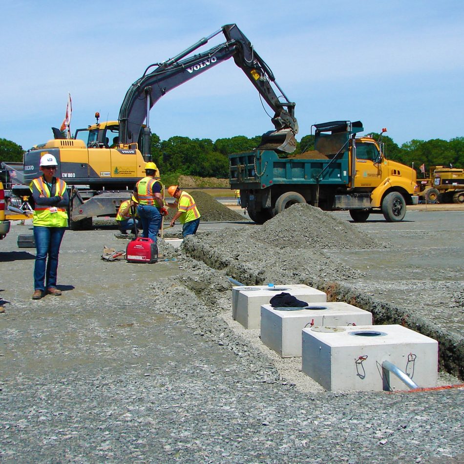 Moulison employees working on in-ground electrical equipment