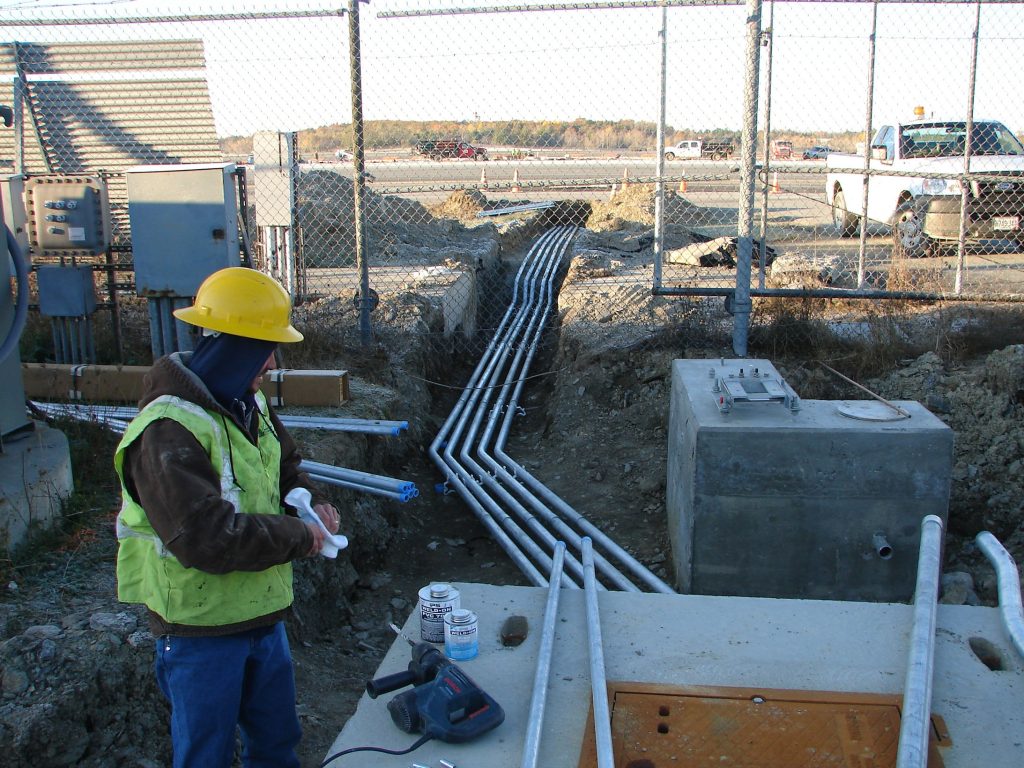 Cables being run under a fence at Bangor International Airport