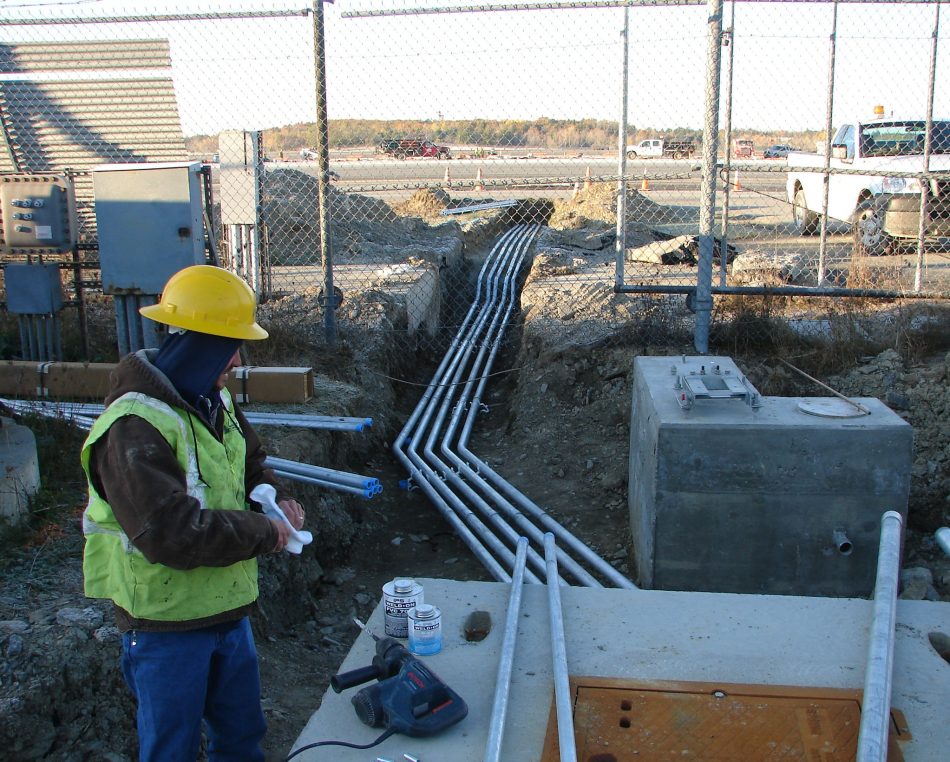 Cables being run under a fence at Bangor International Airport