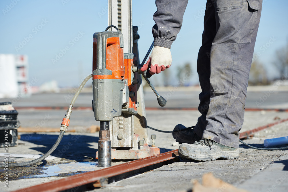 A person using a tool to core drill