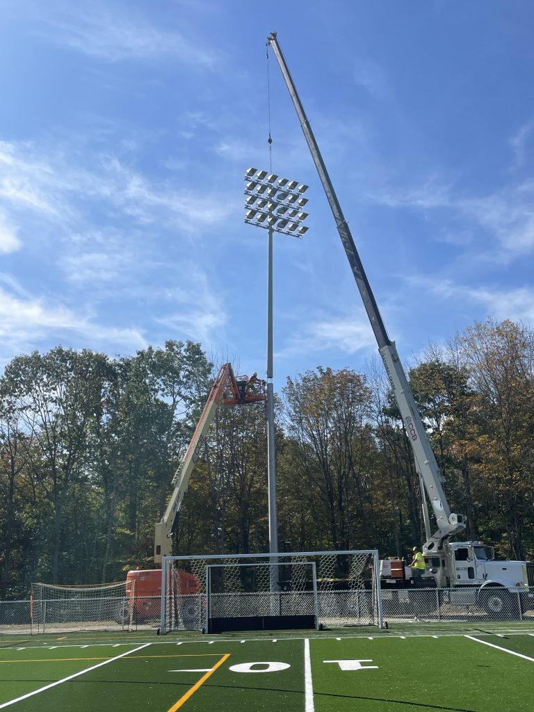 The Moulison team erecting a stadium light